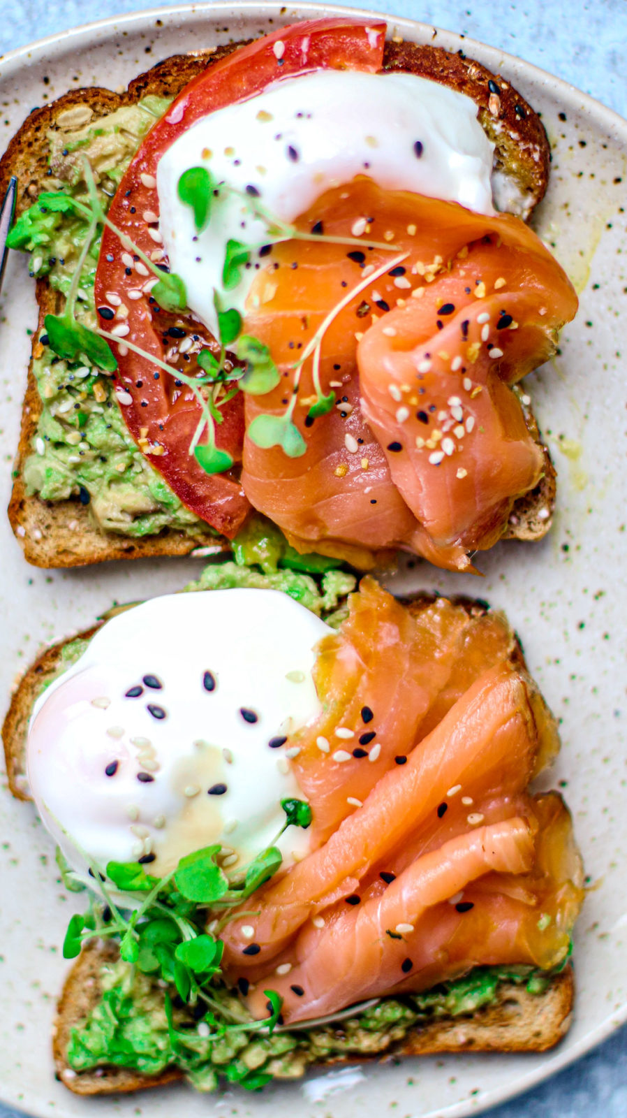 Close up of smoked salmon and poached eggs on toast with avocado.