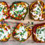 Vegetarian stuffed peppers covered in melted cheese.