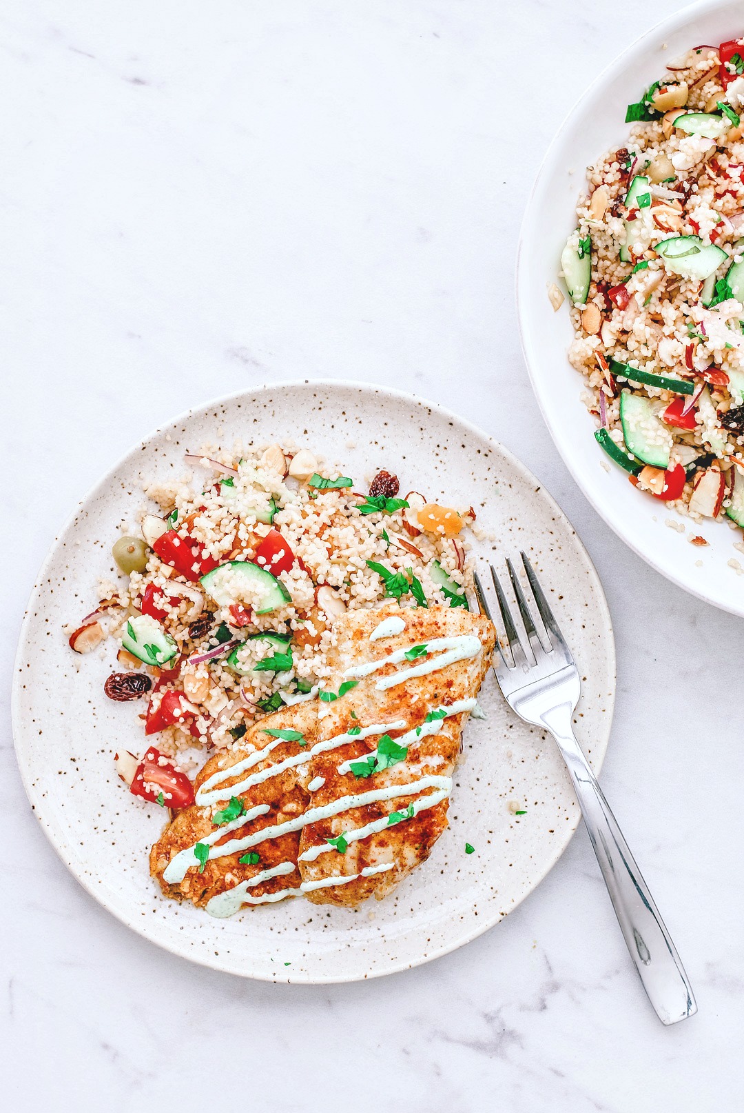Overhead shot of Moroccan-spiced rockfish on bed of couscous salad.