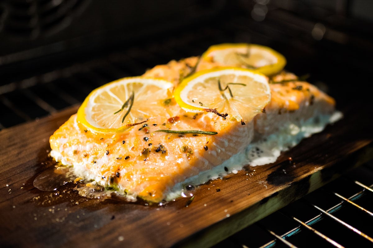Salmon fillet being grilled on cedar plank.
