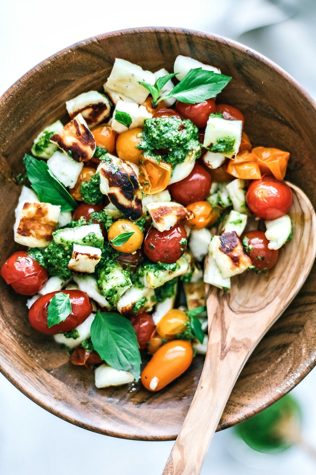 Grilled Halloumi and Burst Tomato Salad With Pesto in a bowl