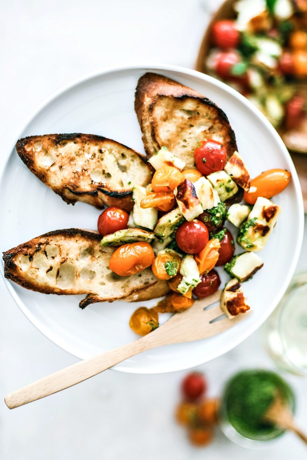 Grilled Halloumi and Burst Tomato Salad With Pesto with grilled bread