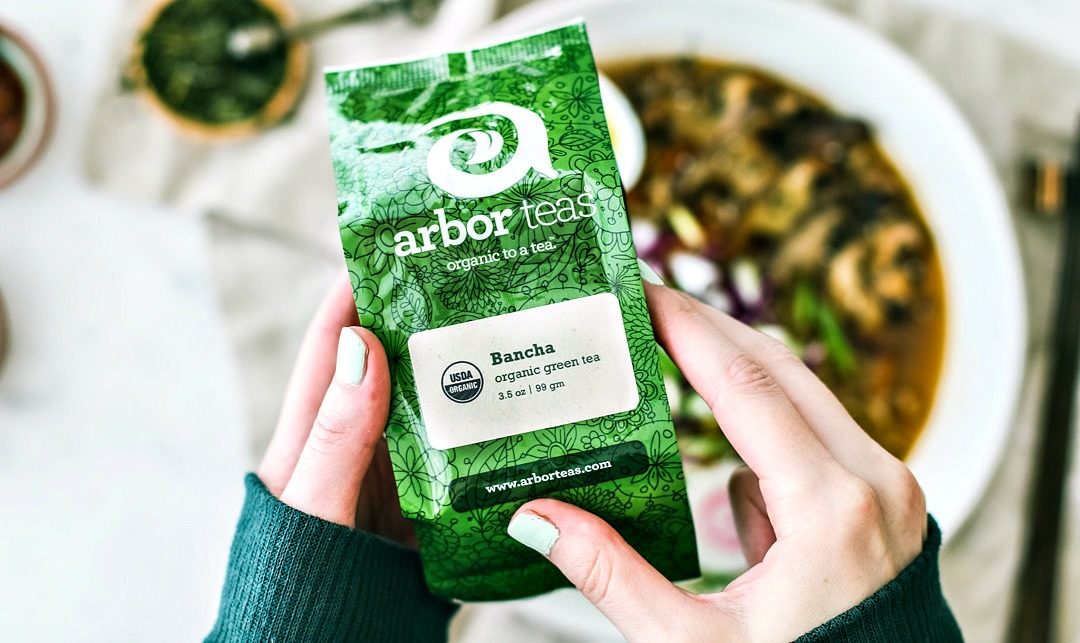 Hands holding Arbor Teas Bancha tea package