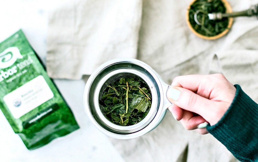 Green tea leaves in infuser