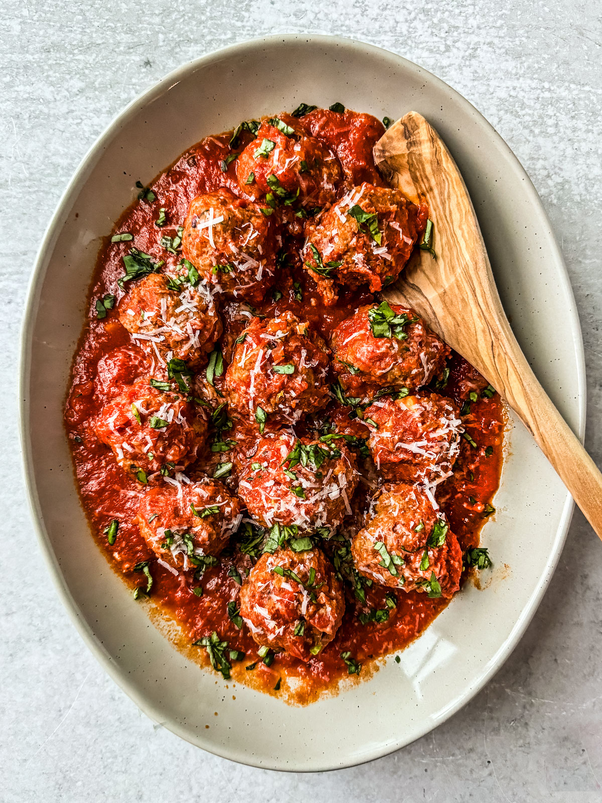 Ground turkey meatballs in sauce presented in a serving dish.