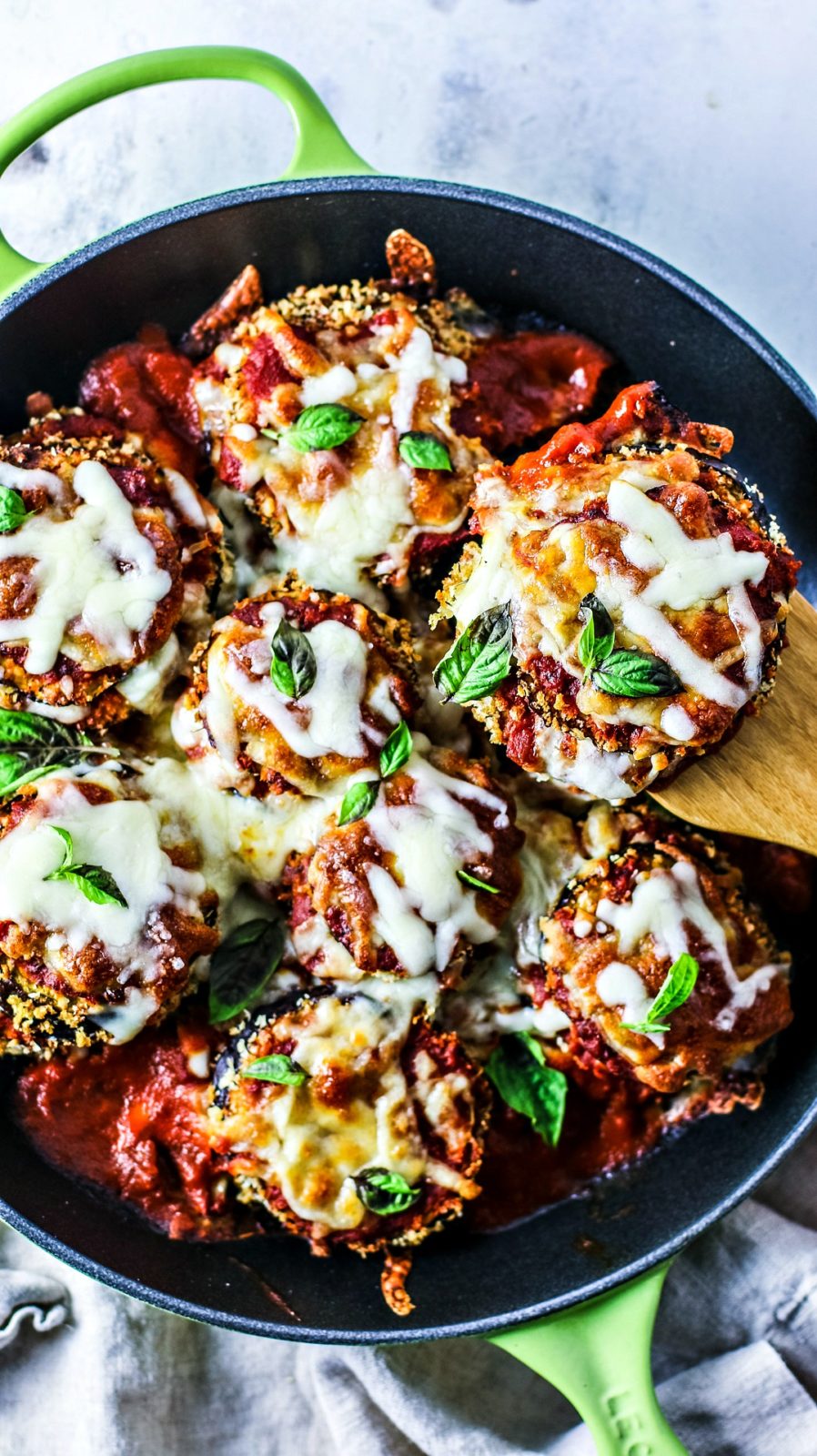 Saucy and cheesy eggplant parmesan in a skillet.