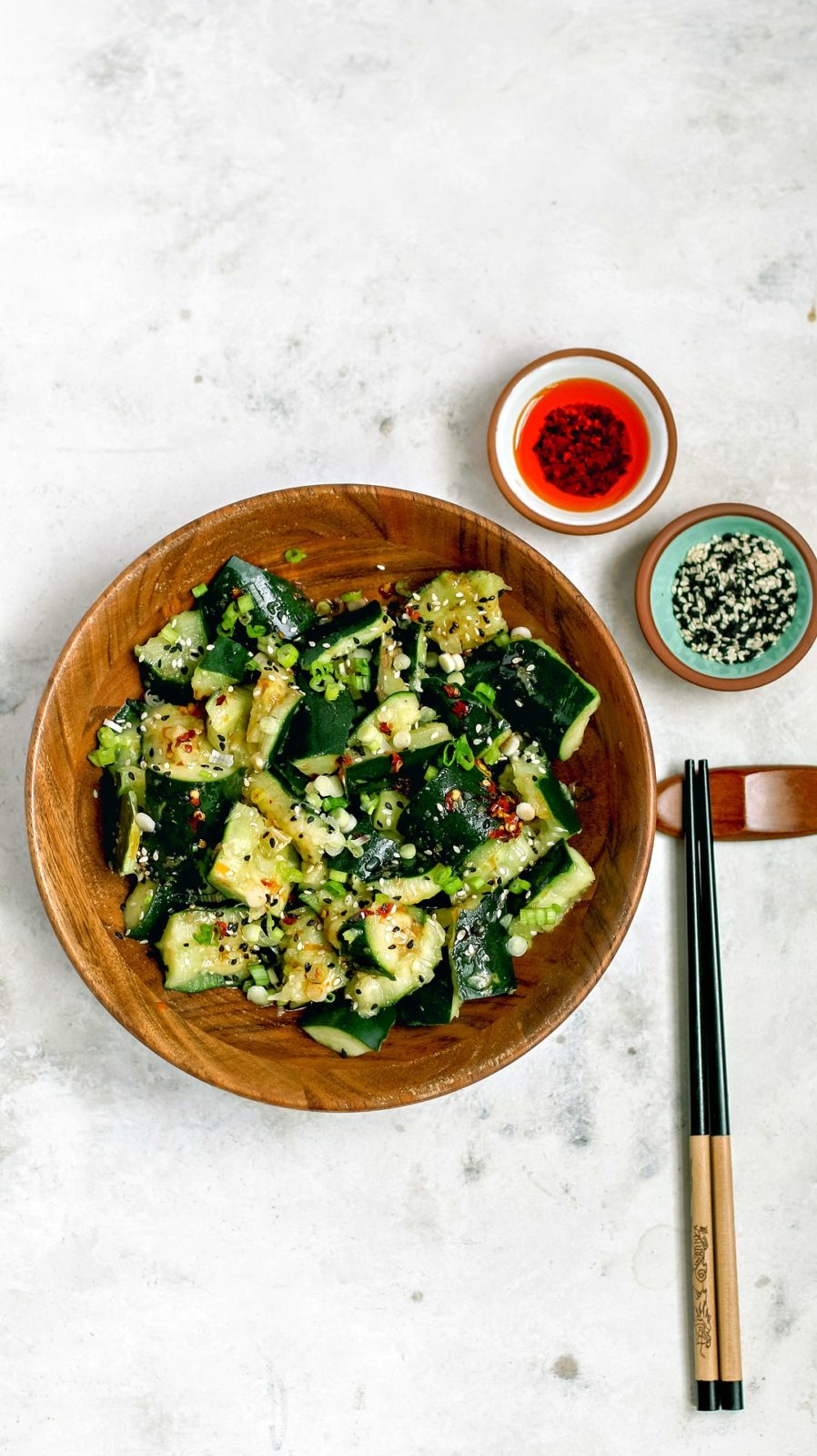 Sichuan Smashed Cucumbers with hot chili oil in a bowl.