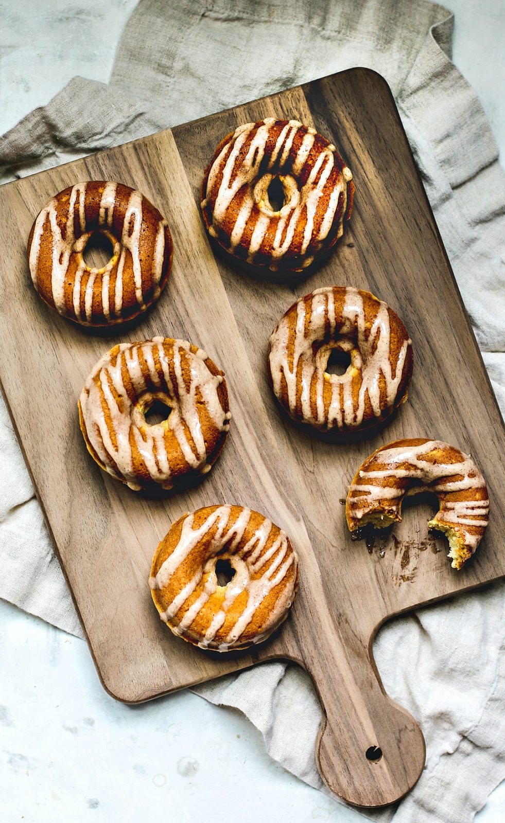 Eggnog donuts drizzled with glaze.