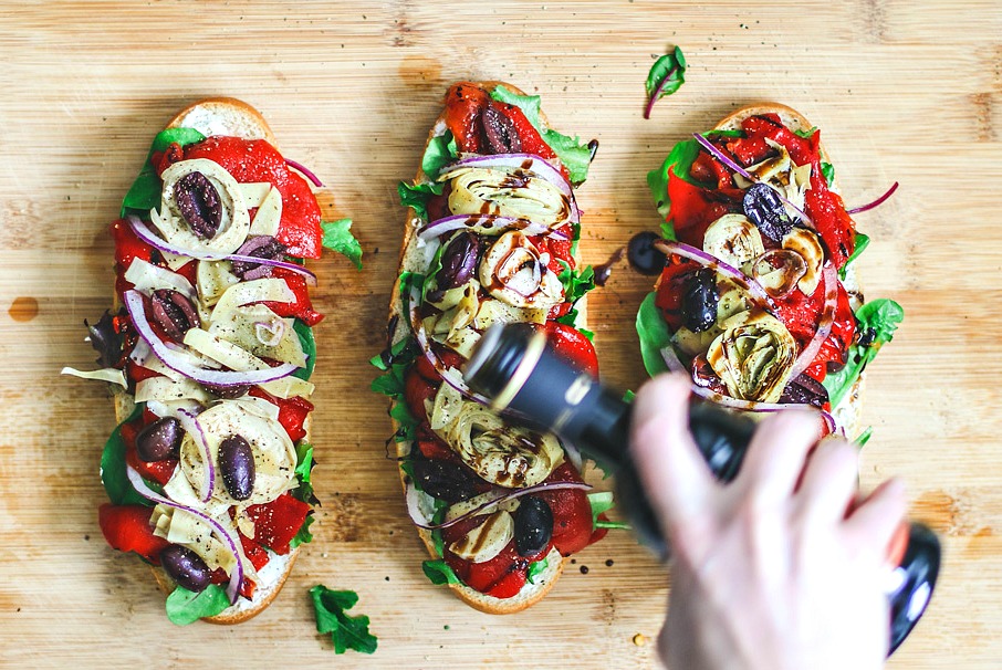 Italian Antipasto Sandwiches being drizzled with balsamic.