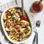 Baking dish full of stuffed pasta shells.