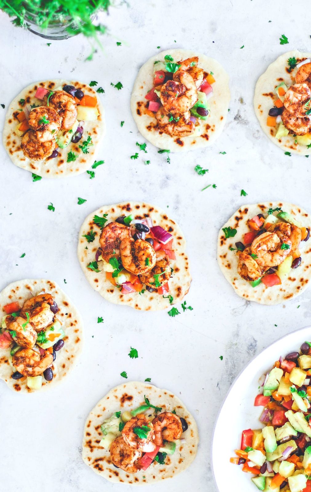 Blackened Shrimp tacos laid out over table.