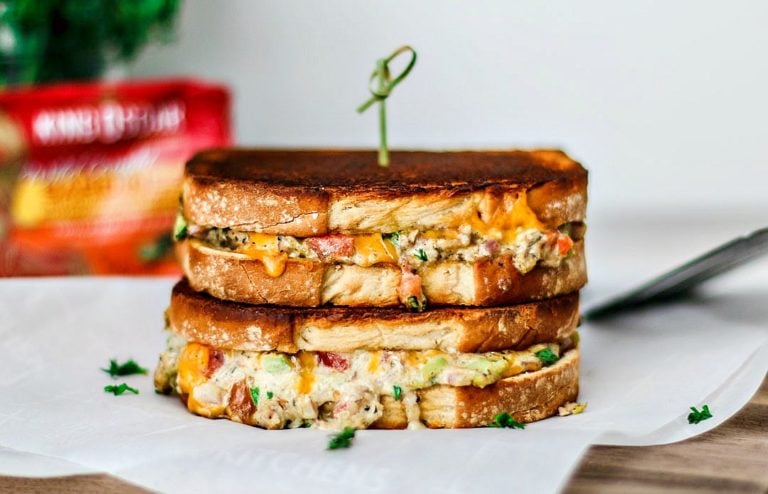 Cheddar Jalape&ntilde;o Gourmet Grilled Cheese sandwiches stacked on top of one another in a melted mess.