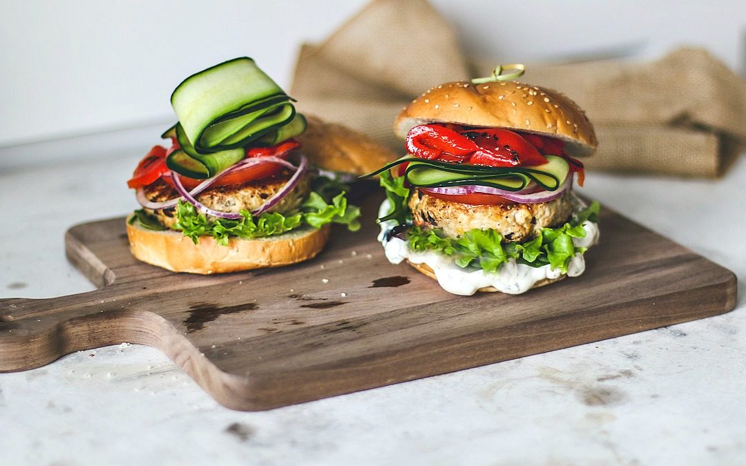 Greek Turkey Burgers stacked with fresh toppings.