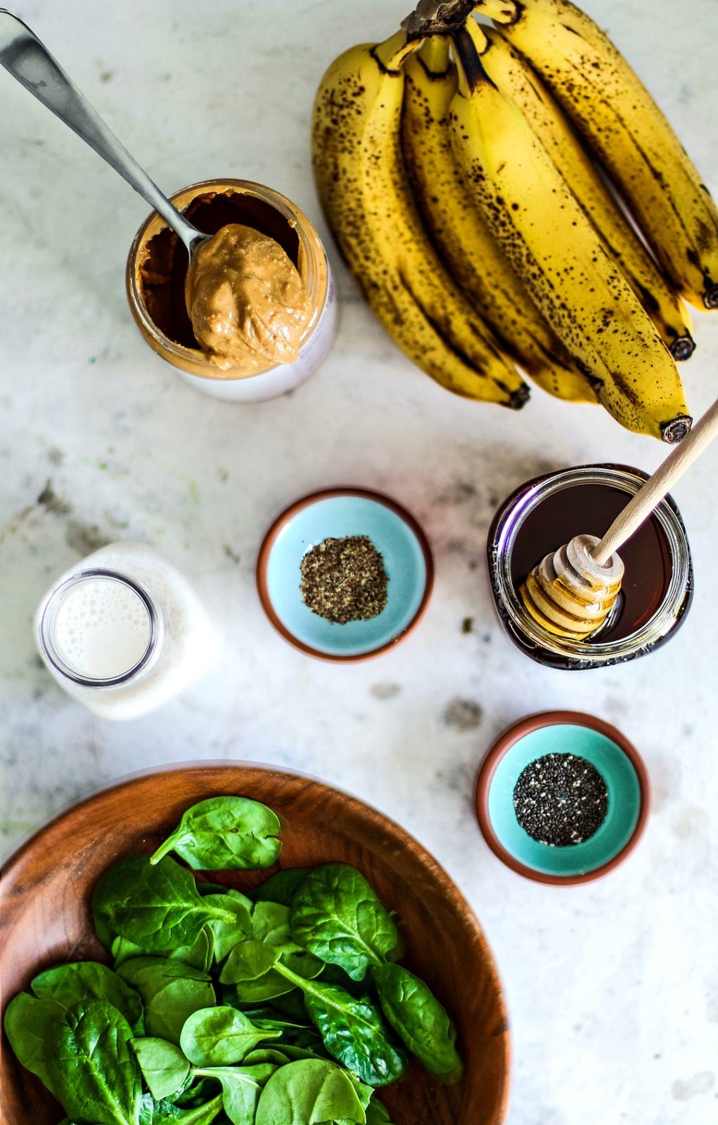 Peanut Butter Banana Spinach Smoothie ingredients on table.