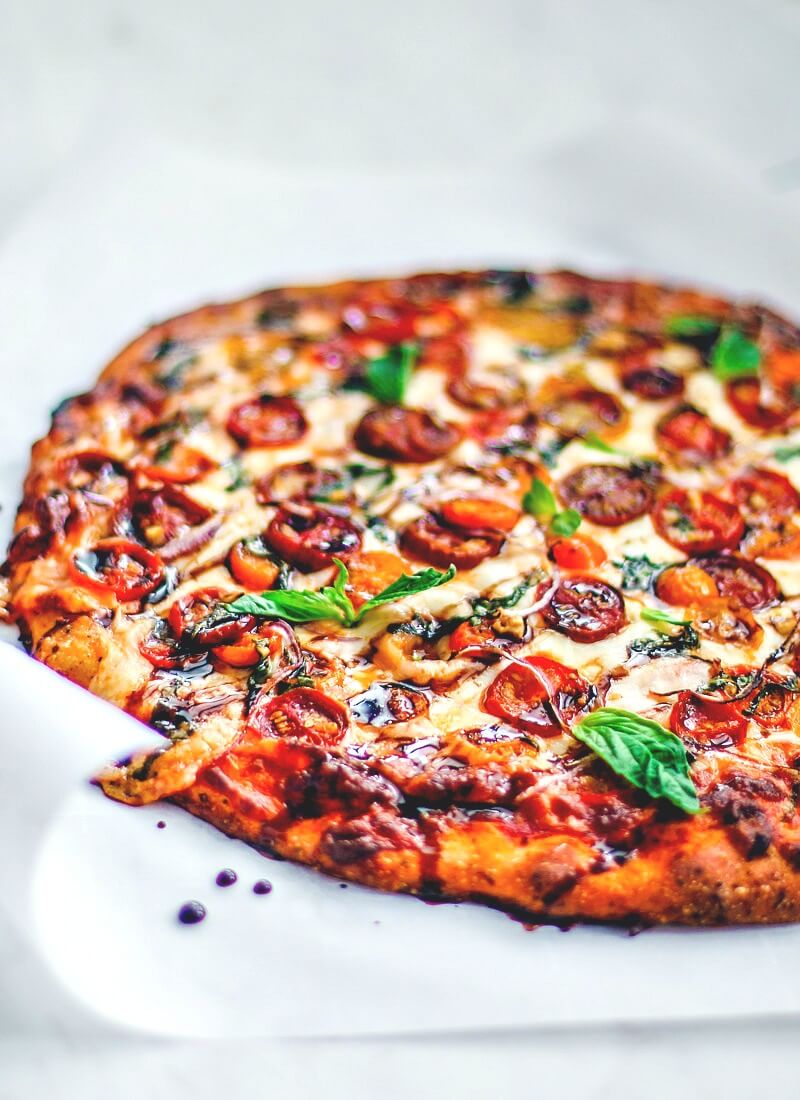 Bruschetta Pizza drizzled with balsamic vinegar.