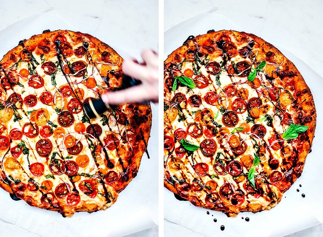 Pizza being drizzled with balsamic/pizza drizzled with balsamic with fresh basil garnish.