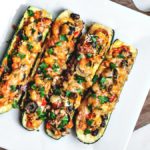 Tex Mex stuffed zucchini boats on a platter.