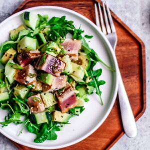 Plate of salad with grilled tuna on top.
