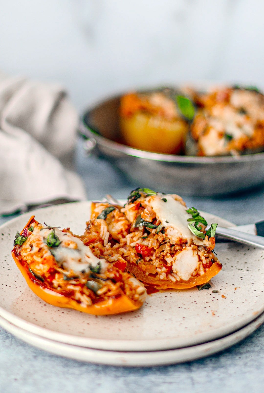 Seafood stuffed pepper cut open on a plate.