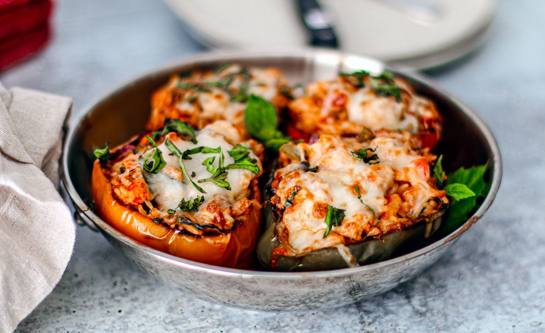 Close up of seafood stuffed peppers on table.