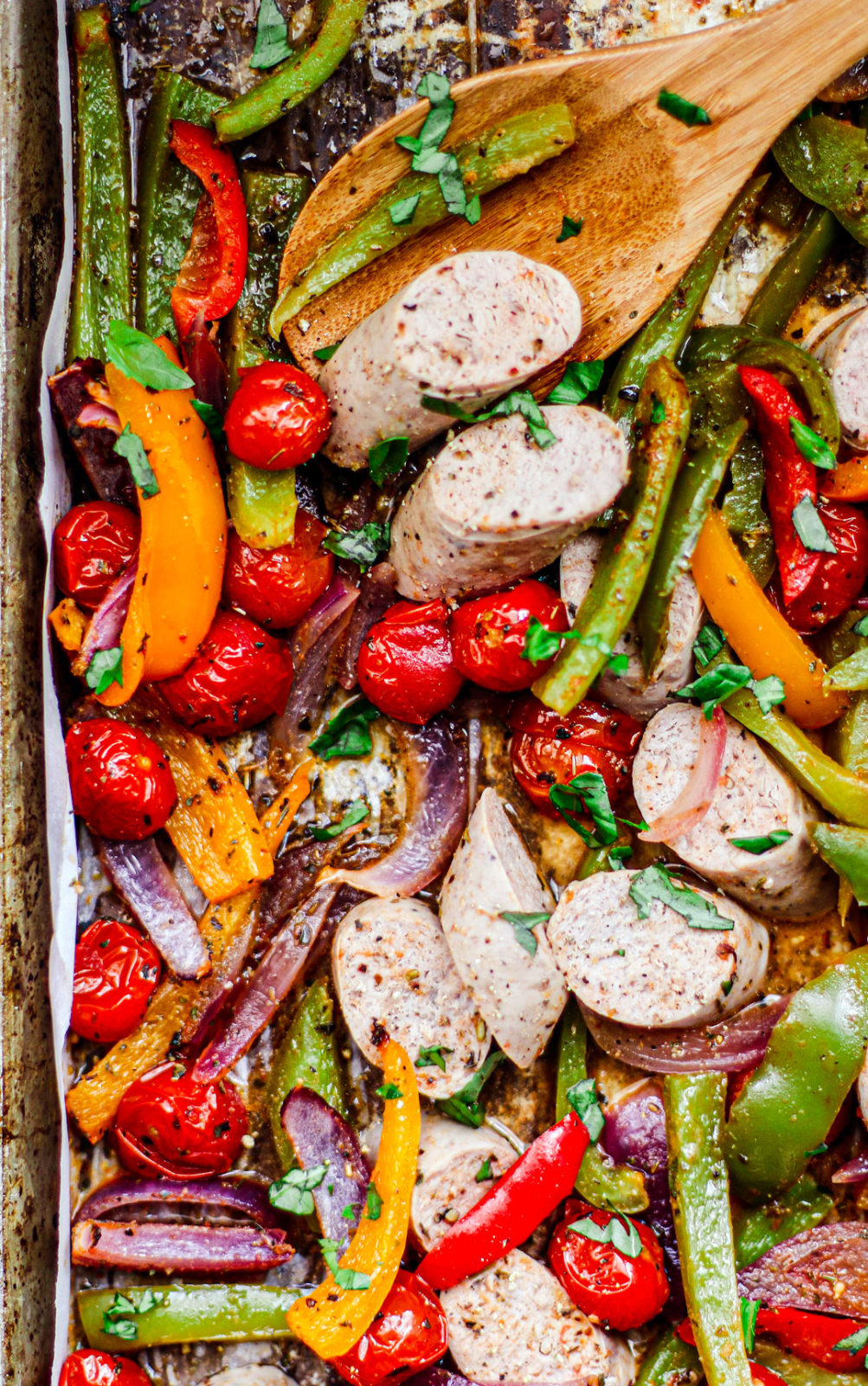 Close up of sheet pan with turkey sausage and veggies.