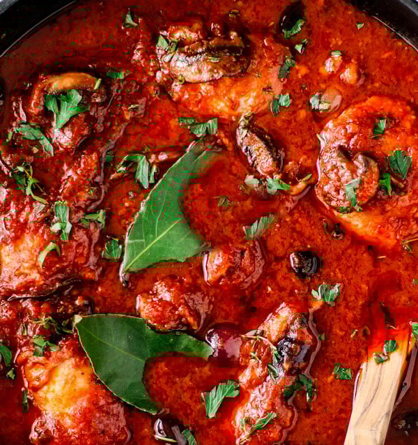 Boneless chicken cacciatore close up in pan.