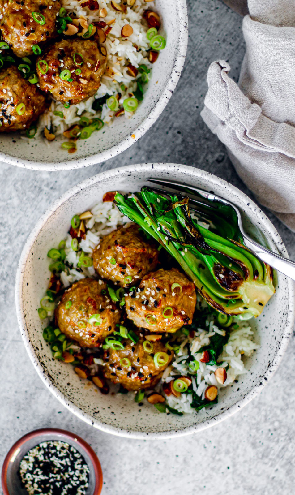 Bowls of garlic and ginger turkey meatballs over rice.