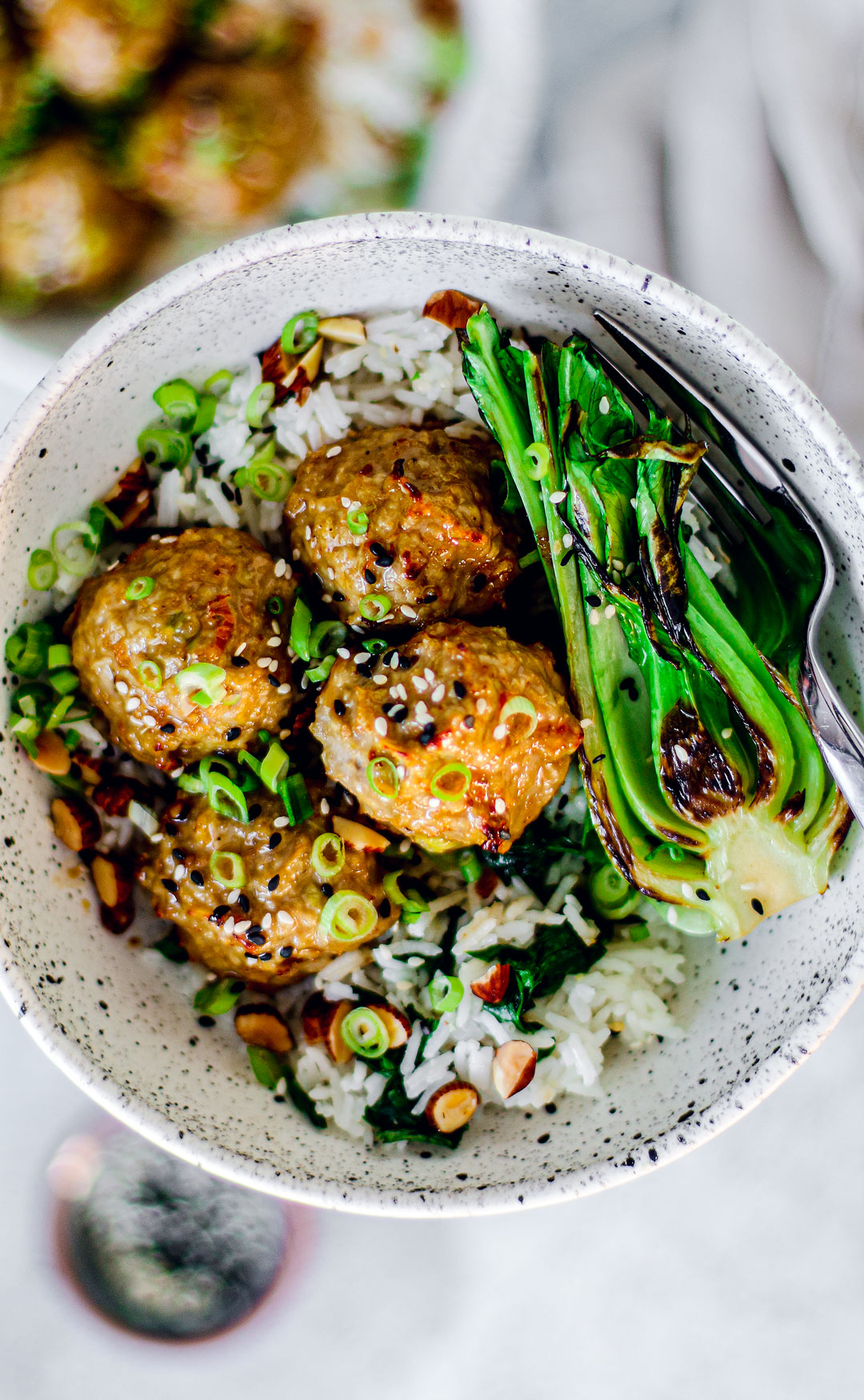Turkey meatballs in a bowl with rice and bok choy.