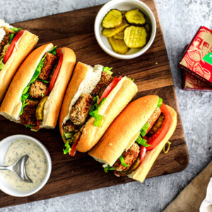 Po'Boy Sandwiches lined up on a cutting board.