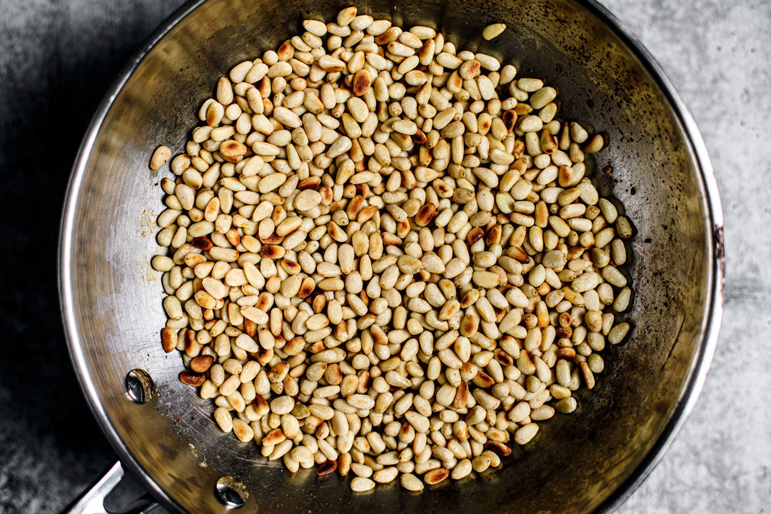 Pan full of toasted pine nuts.