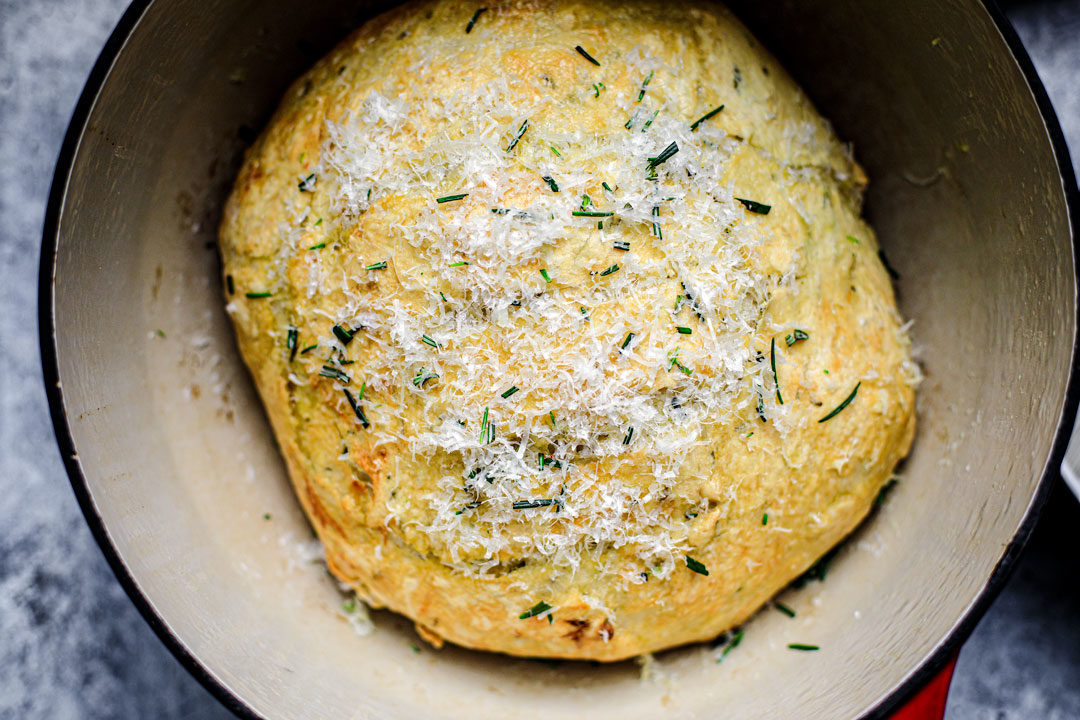 Bread sprinkled with fresh rosemary and grated parmesan.