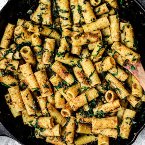 Skillet full of prepared rigatoni pasta.