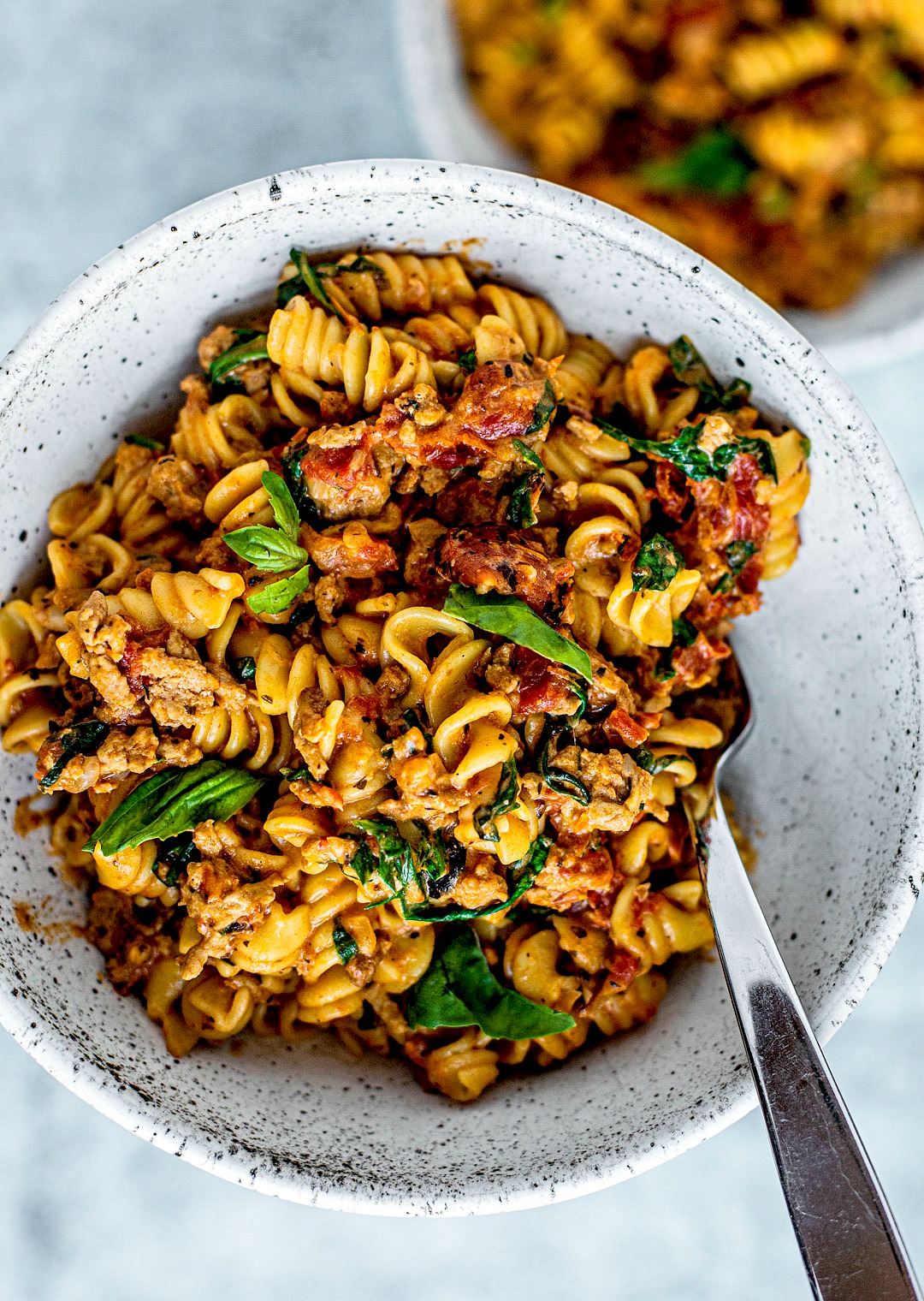 Close up of bowl full of creamy tomato pasta.