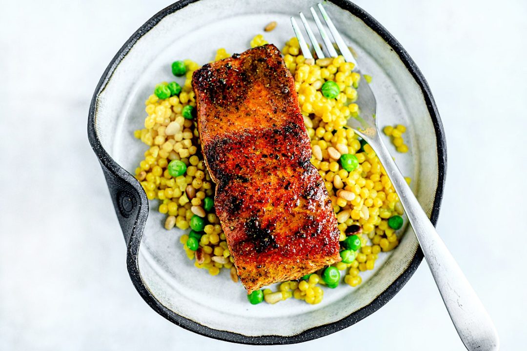 Pan-seared salmon over bed of couscous and peas.