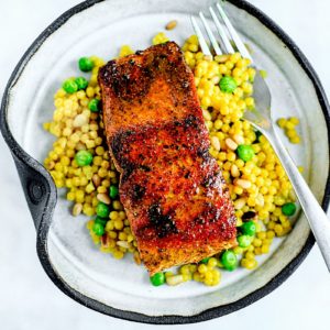 Pan-seared salmon over bed of couscous and peas.