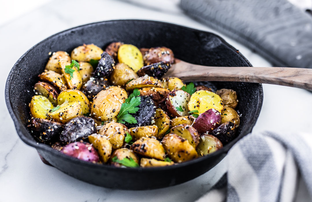 Skillet with multicolored roasted potatoes.