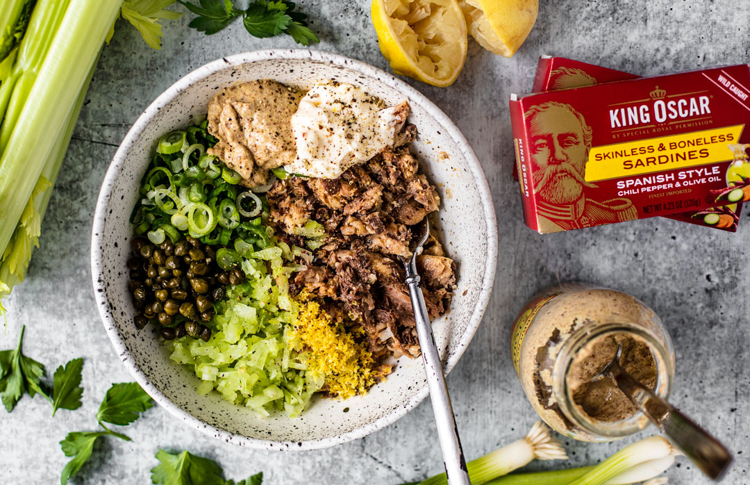 Bowl of sardine salad ingredients with King Oscar packaging next to it.