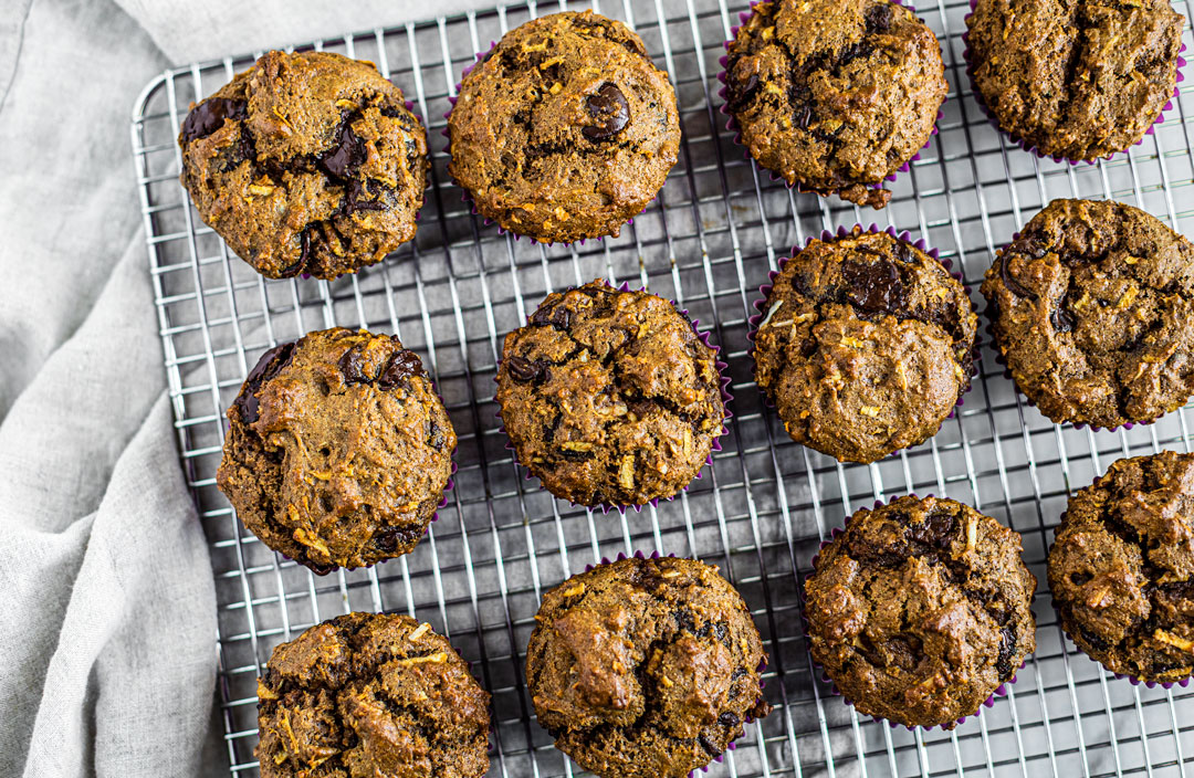 Cooling rack full of whole wheat chocolate chip muffins.