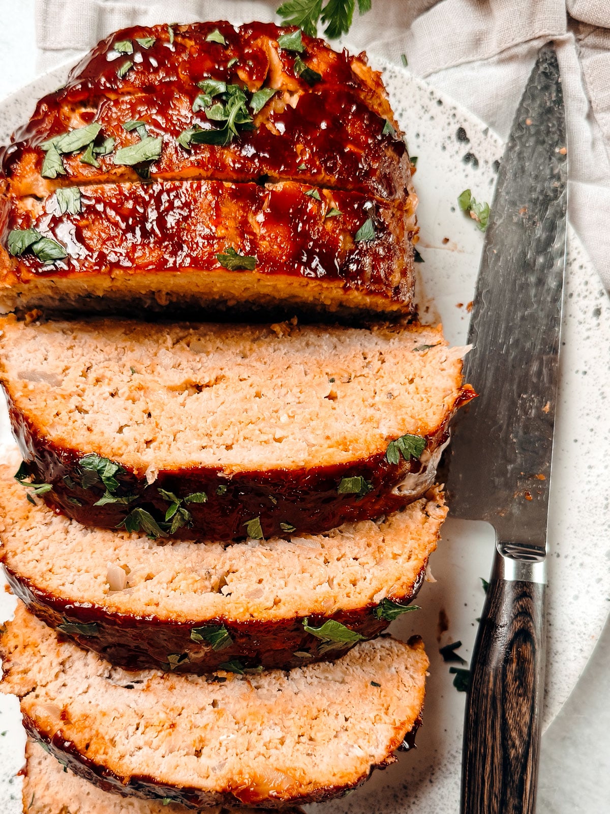 Ground turkey meatloaf sliced on a serving platter.