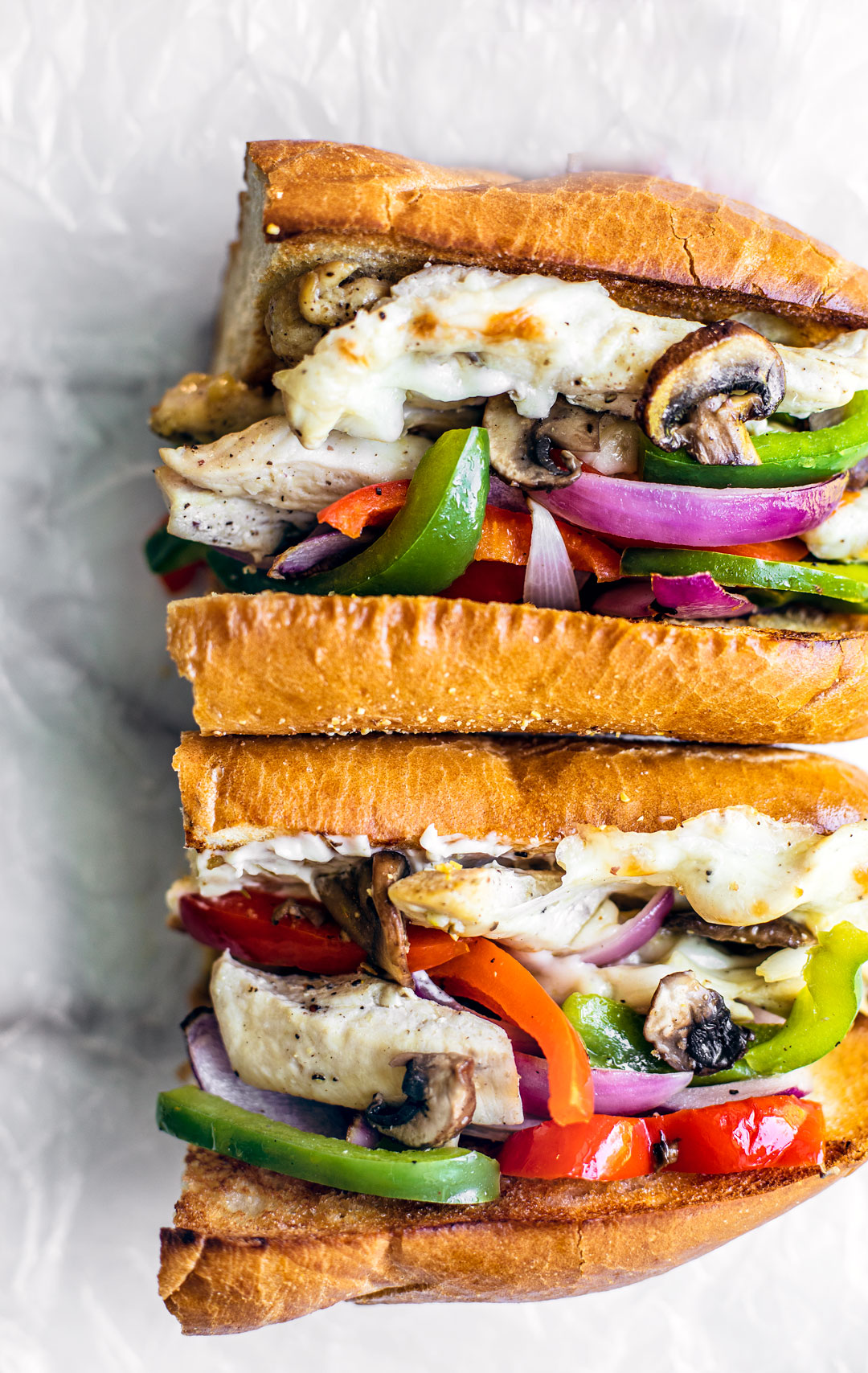 Stacked cheesy chicken philly sandwiches