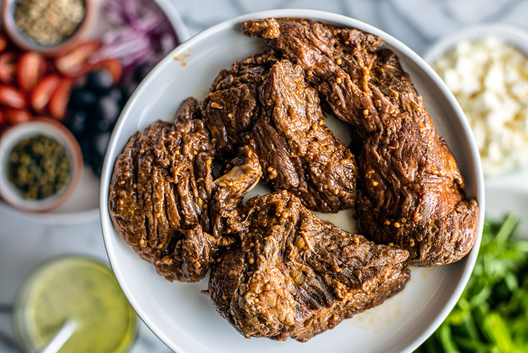 Close up of plate of marinated steak tips on a plate.