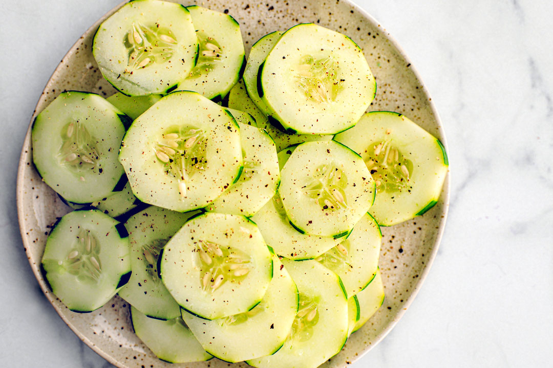 Plate full of peppered cucumber slices.