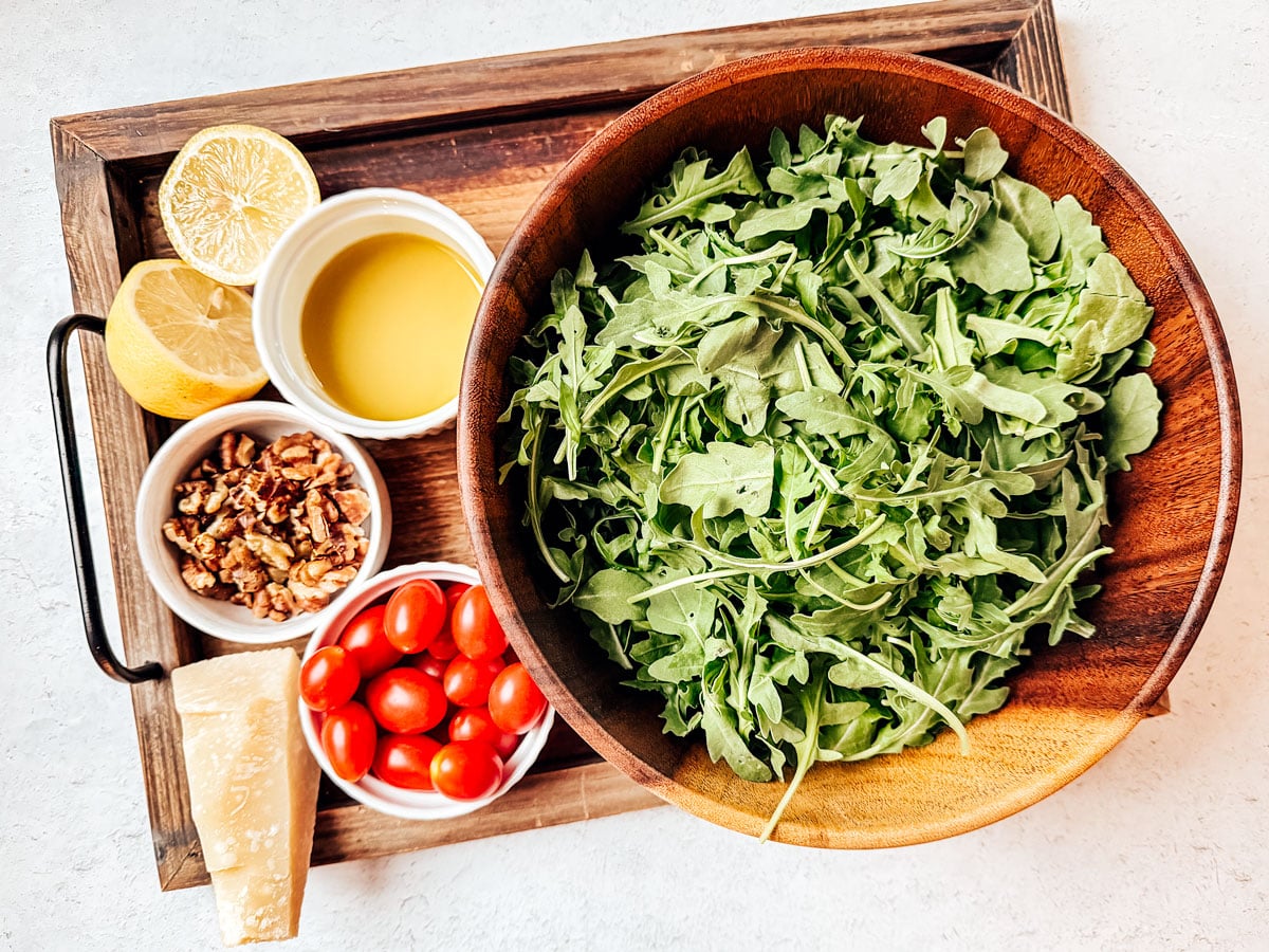 Ingredients for arugula salad on a white background.