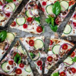 Vertical shot of flatbread slices on a baking sheet.