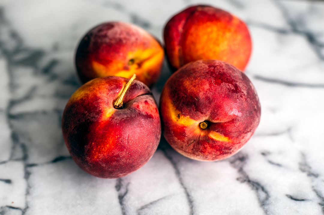 Peaches on marble countertop.