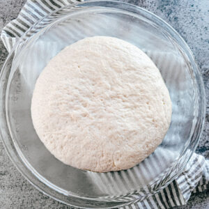 Dough ball in a glass bowl.