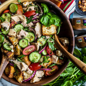 Large serving bowl full of colorful panzanella salad with tuna.