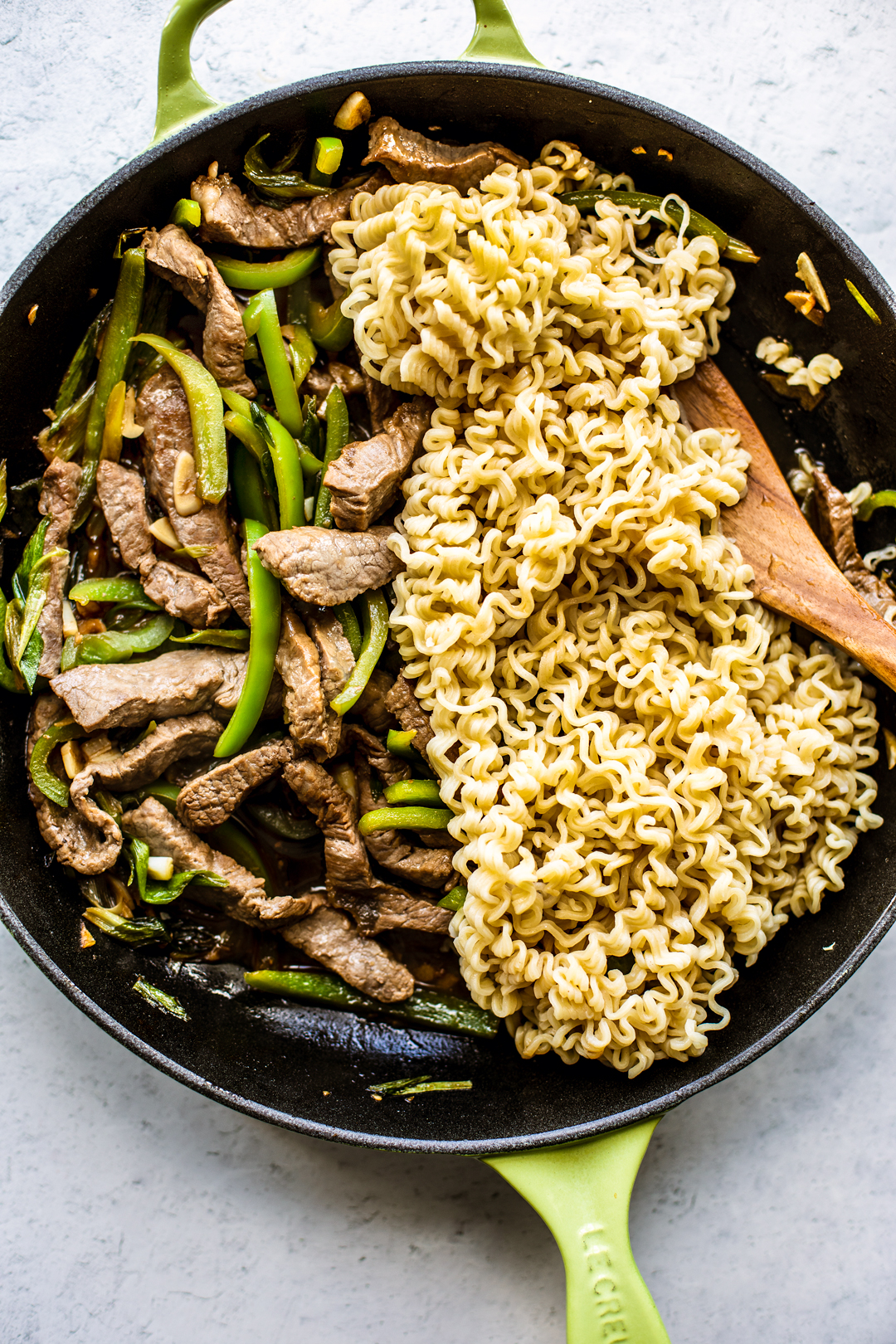 Skillet full of beef and peppers with Ramen noodles.