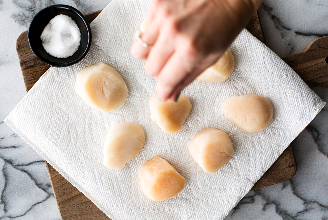 Scallops being salted.