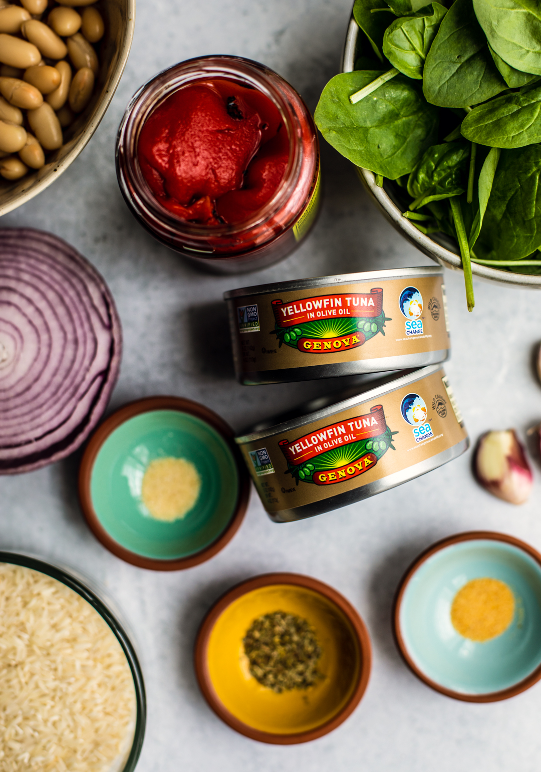 Two cans of Genova tuna with other bright and fresh ingredients.